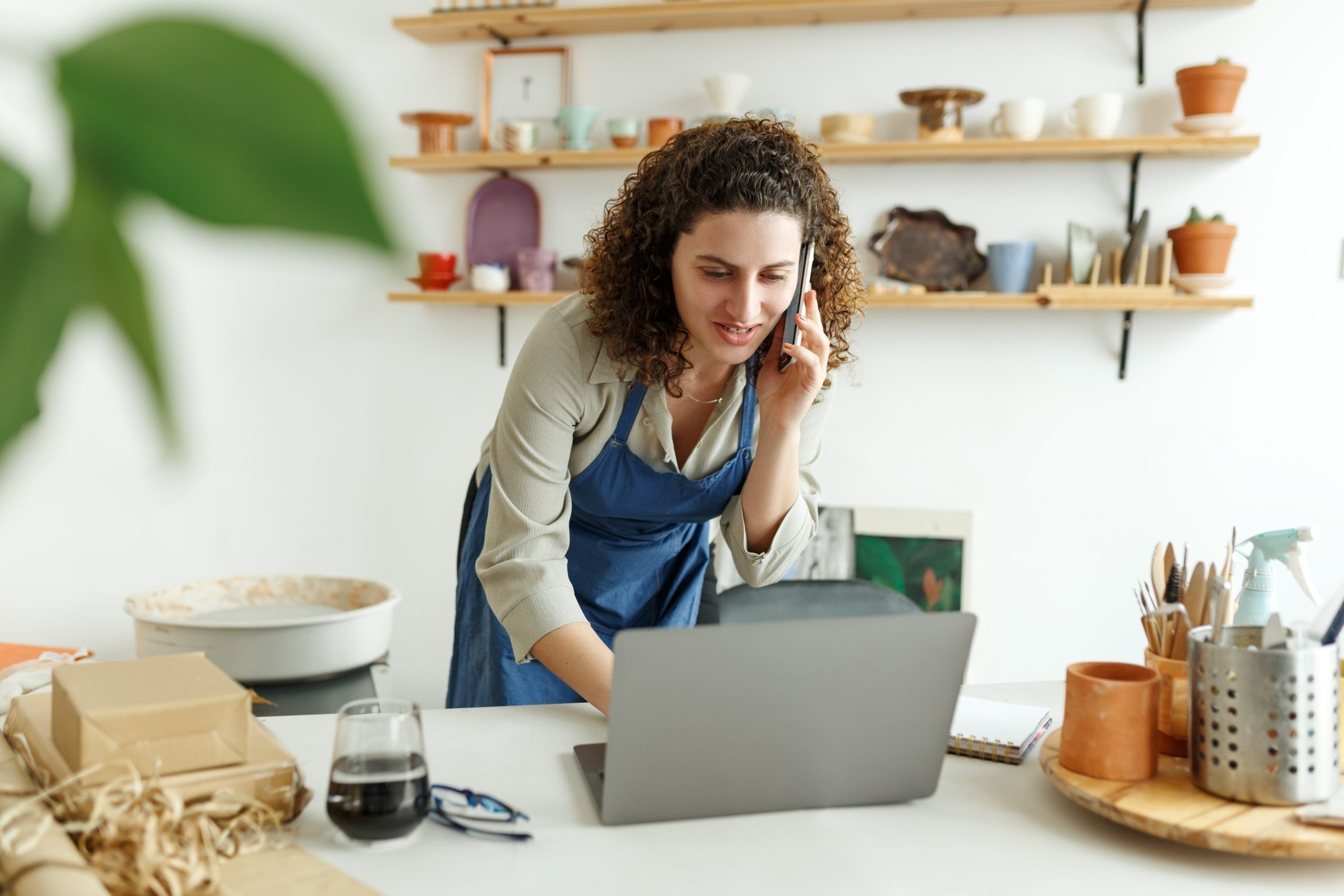 potter-entrepreneur-using-laptop-in-workshop-smil-2023-02-01-00-39-46-utc-scaled.jpg